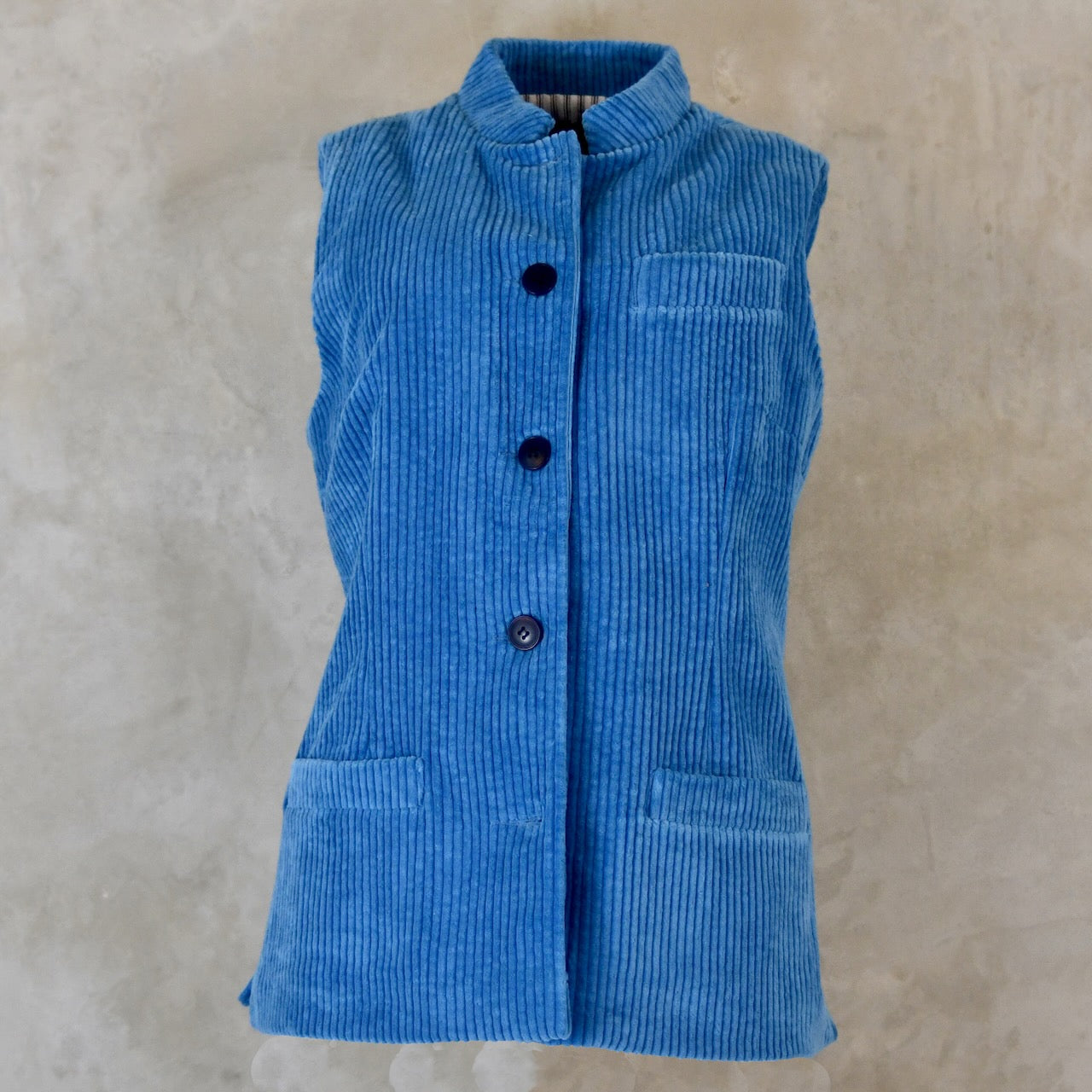 Blue Cotton Corduroy Ladies Waistcoat. 
Handmade in London this longer length Gilet has a Nehru collar and bllue corozo buttons.