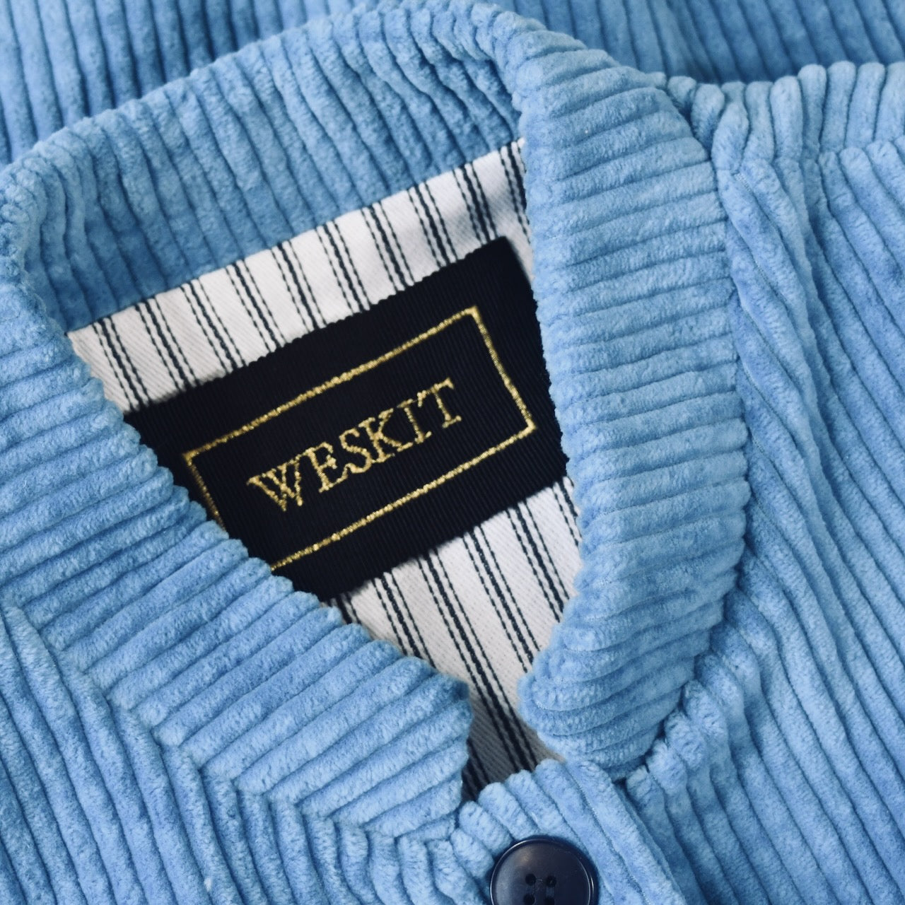 Collar detail on Blue Cotton Corduroy Ladies Waistcoat. 
Handmade in London this longer length Gilet has a Nehru collar and bllue corozo buttons.