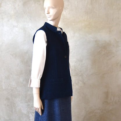 Side Shot of Ladies Shaped Gilet in Linton Tweeds boucle. A deep navy spring-summer weight fabric, this gilet packs superbly and can be worn everywhere. Handmade in London. 