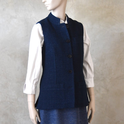 Buttoned up Angled Side Shot of Ladies Shaped Gilet in Linton Tweeds boucle. A deep navy spring-summer weight fabric, this gilet packs superbly and can be worn everywhere. Handmade in London. 