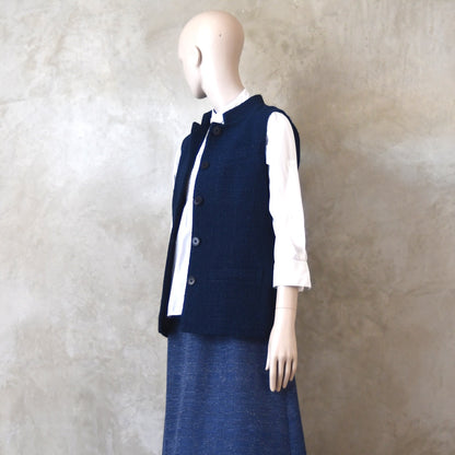 Angled Side Shot of Ladies Shaped Gilet in Linton Tweeds boucle. A deep navy spring-summer weight fabric, this gilet packs superbly and can be worn everywhere. Handmade in London. 