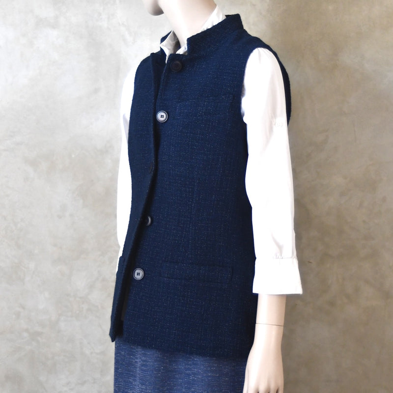 Angled Side Shot of Ladies Shaped Gilet in Linton Tweeds boucle. A deep navy spring-summer weight fabric, this gilet packs superbly and can be worn everywhere. Handmade in London.  Buttoned up view.