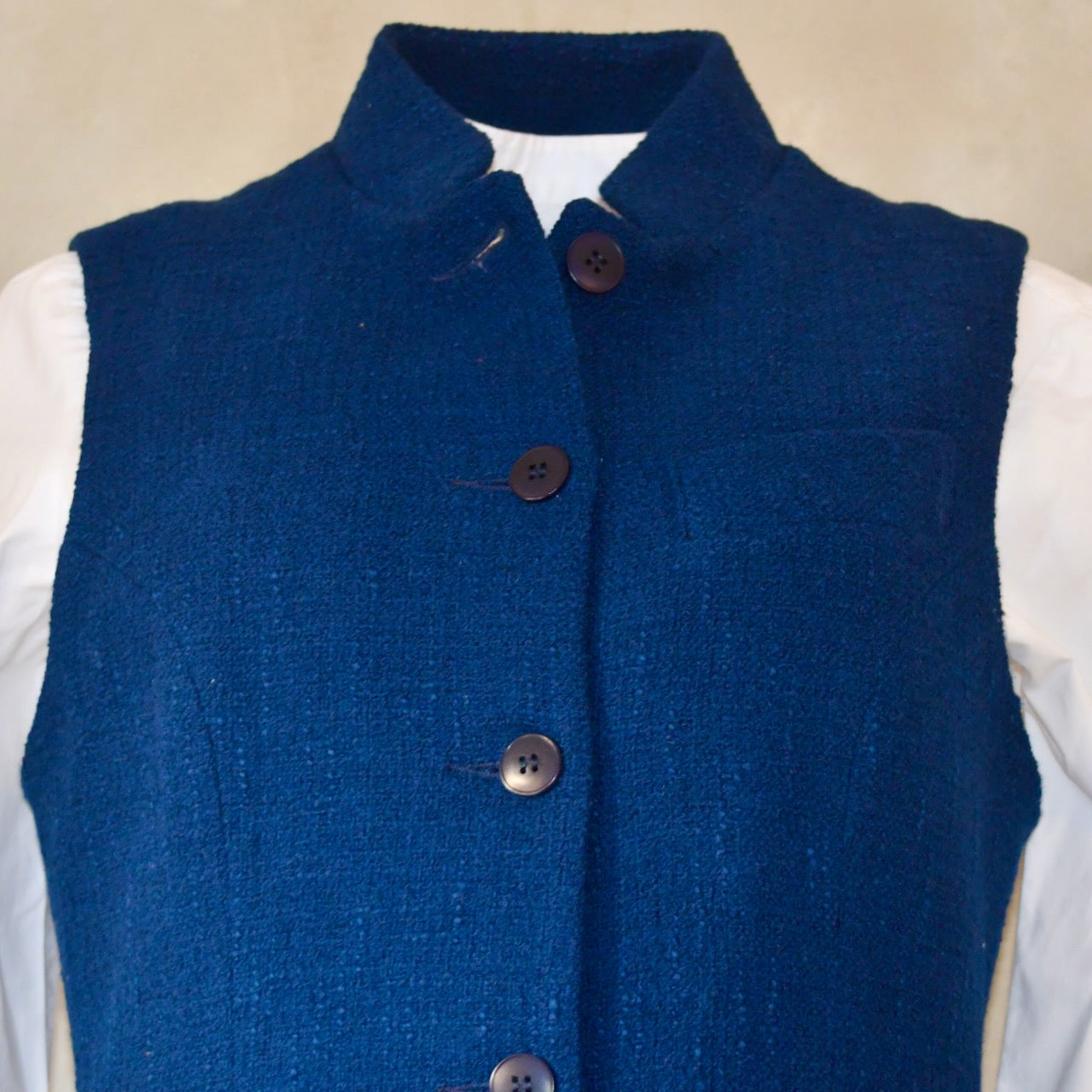 Close up of Navy Ladies' Waistcoat in Linton Tweeds Boucle. This pure cotton boucle has a lightweight feel and a gentle handle. Perfect for spring, autumn and cooler summer days. Handmade in London.