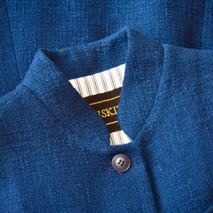 Collar Close up showing embroidered label on Navy Ladies' Waistcoat in Linton Tweeds Boucle. This pure cotton boucle has a lightweight feel and a gentle handle. Perfect for spring, autumn and cooler summer days. Handmade in London.