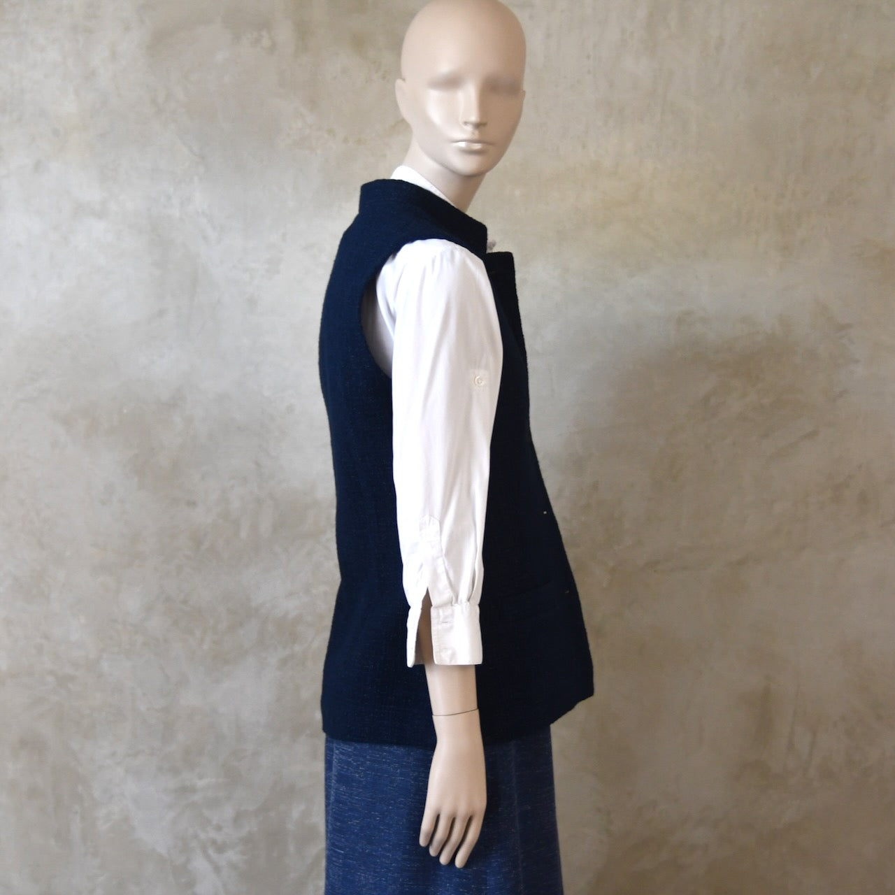 Full Side Shot of Ladies Shaped Gilet in Linton Tweeds boucle. A deep navy spring-summer weight fabric, this gilet packs superbly and can be worn everywhere. Handmade in London. 