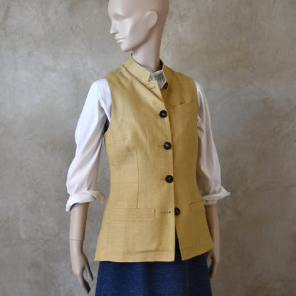 Buttoned angled view of Ladies Silk Gilet in Sand coloured Silk Matka. Handmade in London with a Nehru Collar and Horn buttons.