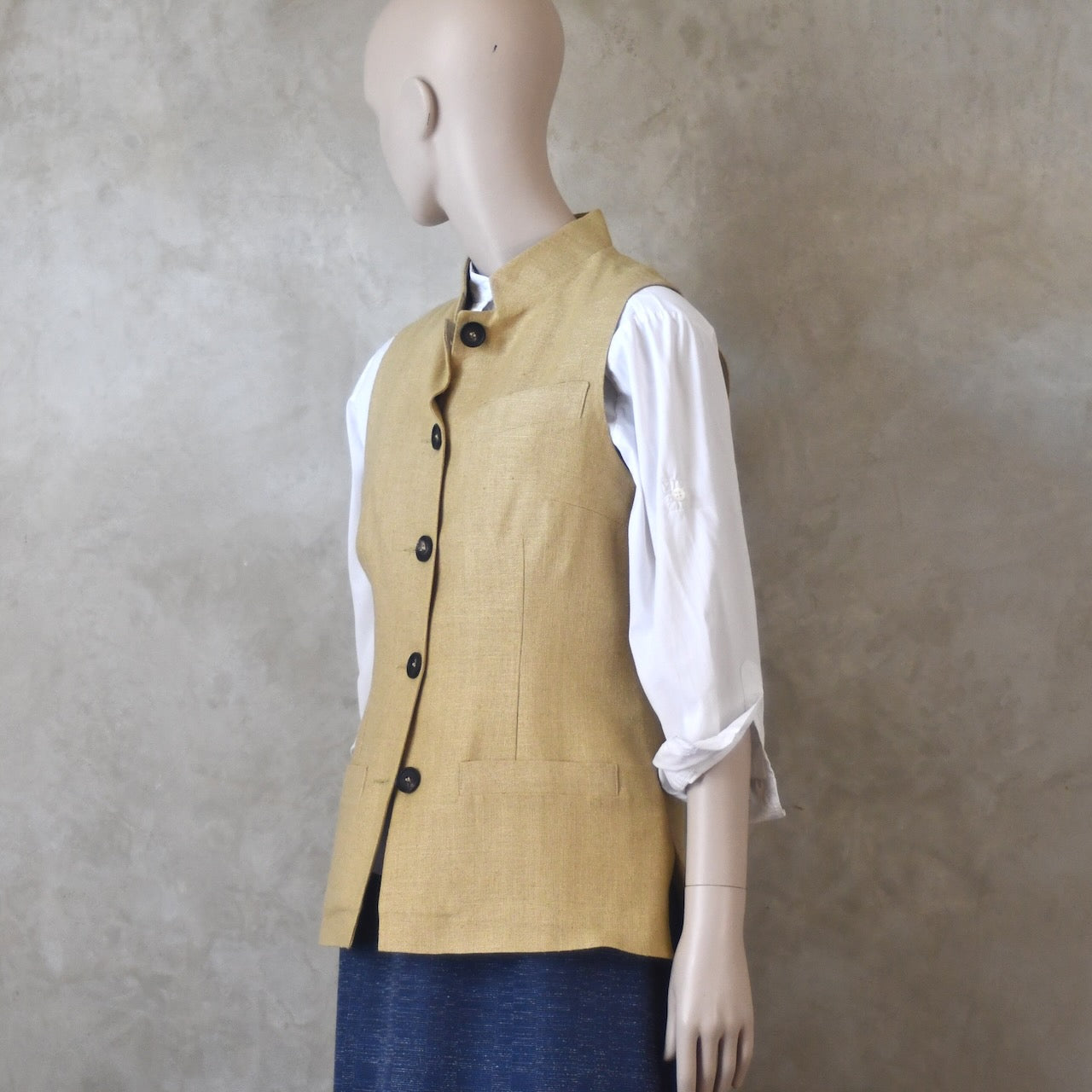 Buttoned side angled view of Ladies Silk Gilet in Sand coloured Silk Matka. Handmade in London with a Nehru Collar and Horn buttons.