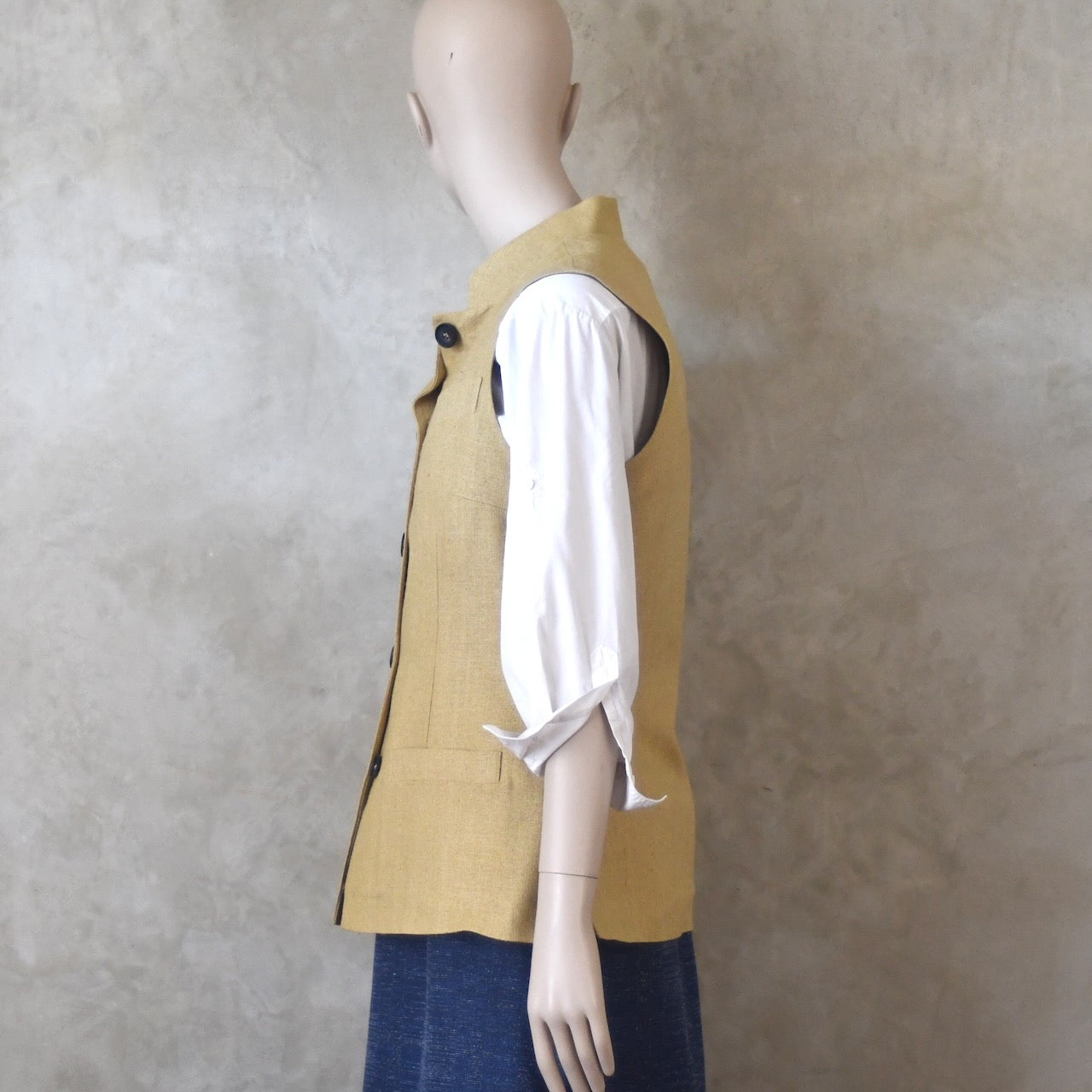 Buttoned side view of Ladies Silk Gilet in Sand coloured Silk Matka. Handmade in London with a Nehru Collar and Horn buttons.