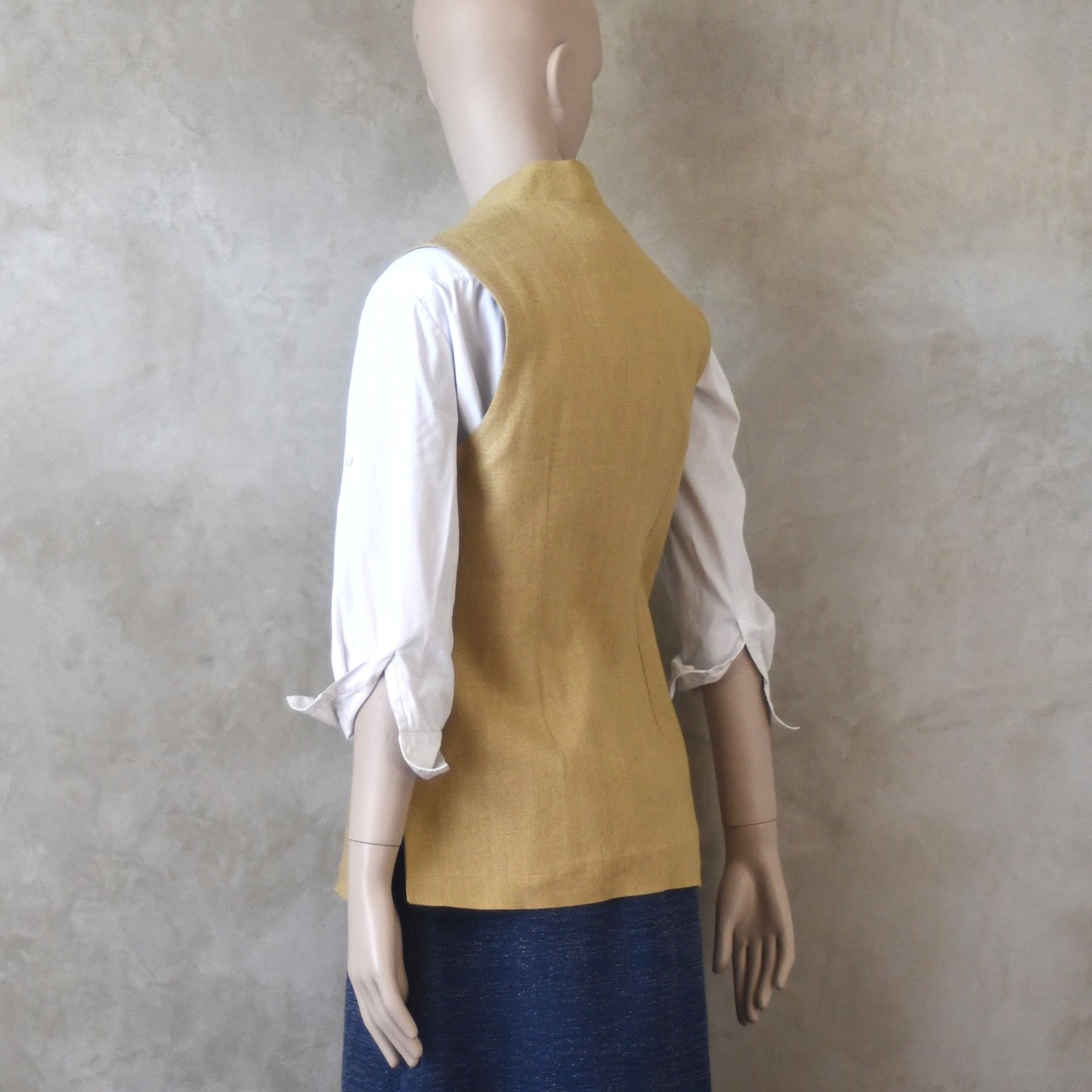 Back angled view of Ladies Silk Gilet in Sand coloured Silk Matka. Handmade in London with a Nehru Collar and Horn buttons.