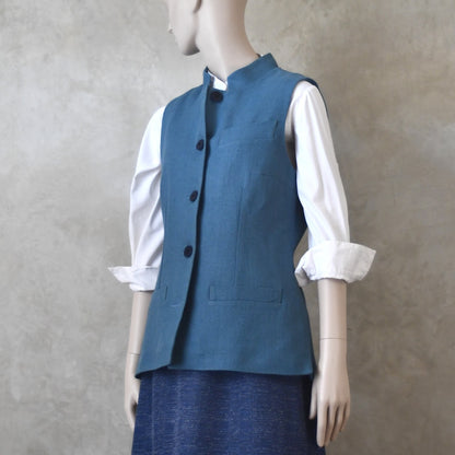 Side View of Ladies Gilet in Light Blue Irish Linen. Handmade in London this waistcoat has a Nehru collar, cotton ticking lining, bust darts as well as front and rear waist-shaping darts.