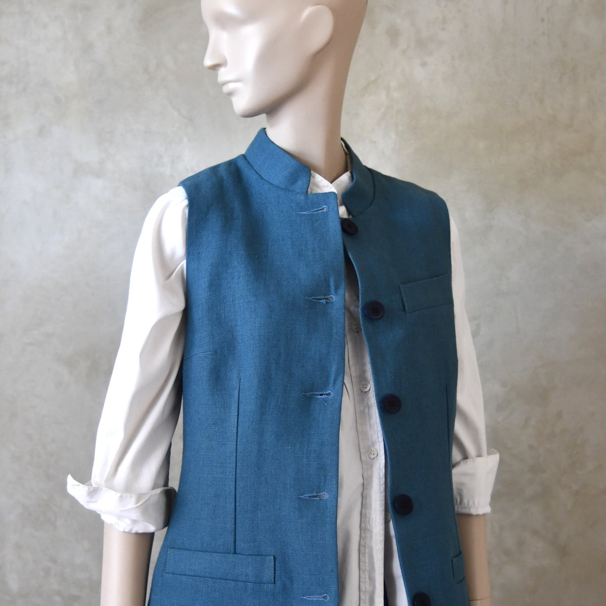Ladies Gilet in Light Blue Irish Linen. Handmade in London this waistcoat has a Nehru collar, cotton ticking lining, bust darts as well as front and rear waist-shaping darts.