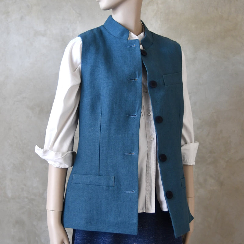 Open view of Ladies Gilet in Light Blue Irish Linen. Handmade in London this waistcoat has a Nehru collar, cotton ticking lining, bust darts as well as front and rear waist-shaping darts.