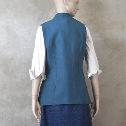 Back View of Ladies Gilet in Light Blue Irish Linen. Handmade in London this waistcoat has a Nehru collar, cotton ticking lining, bust darts as well as front and rear waist-shaping darts.
