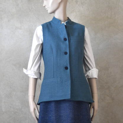 Front View of Ladies Gilet in Light Blue Irish Linen. Handmade in London this waistcoat has a Nehru collar, cotton ticking lining, bust darts as well as front and rear waist-shaping darts.