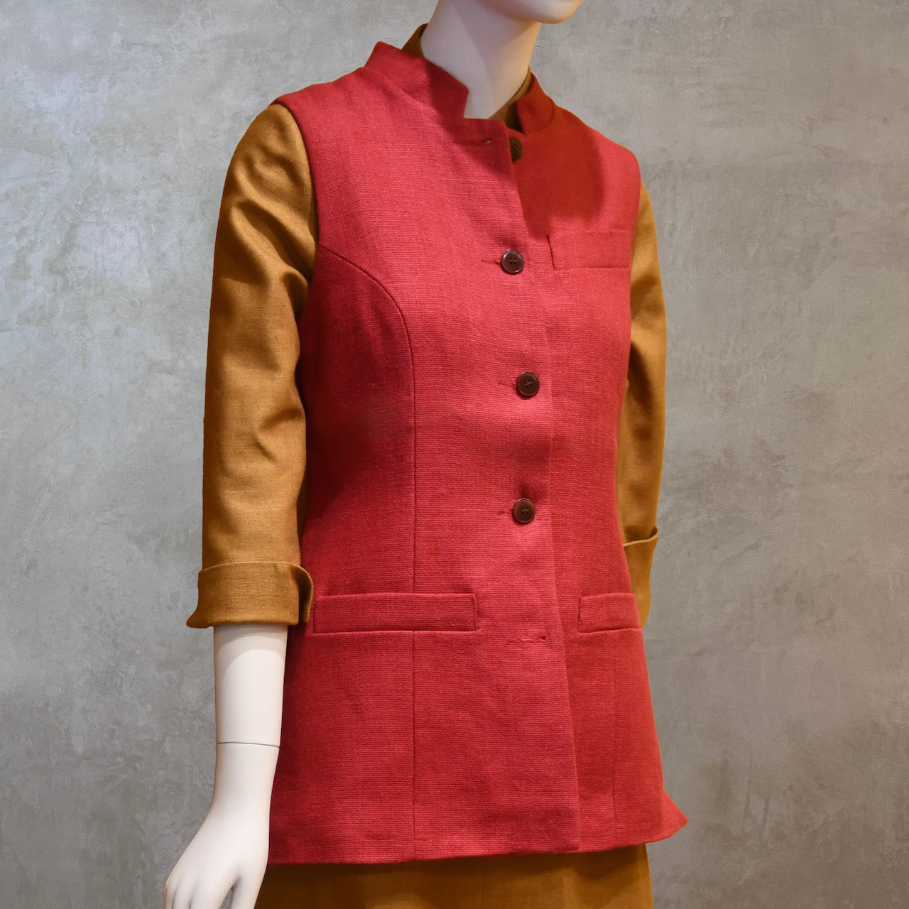 Ladies Shaped Gilet in Red Irish linen. Handmade in London the waistcoat is shown worn over a mustard coloured silk dress by EdNerat.