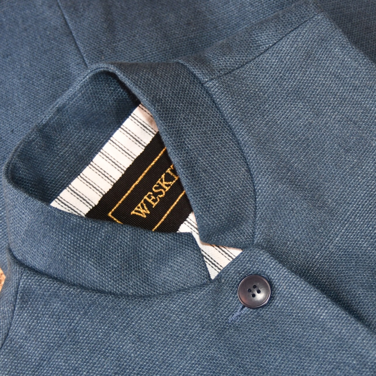 Close up Collar Detail showing embroidered label on Ladies Gilet in Navy Linen. Made from a Heavy Weight Pure Irish Linen, this waistcoat is hand cut made and finished in London.