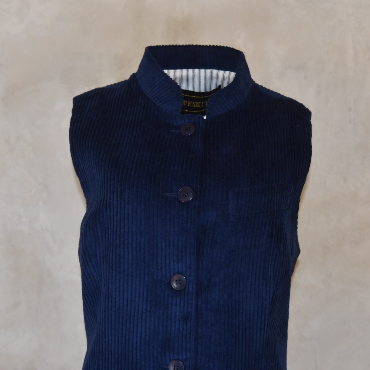 Detail View of Ladies Dark Navy Cord Waistcoat. This pure cotton corduroy gilet is handmade in London. With a mandarin collar and smart cotton stripe ticking this gilet is made to last and last.