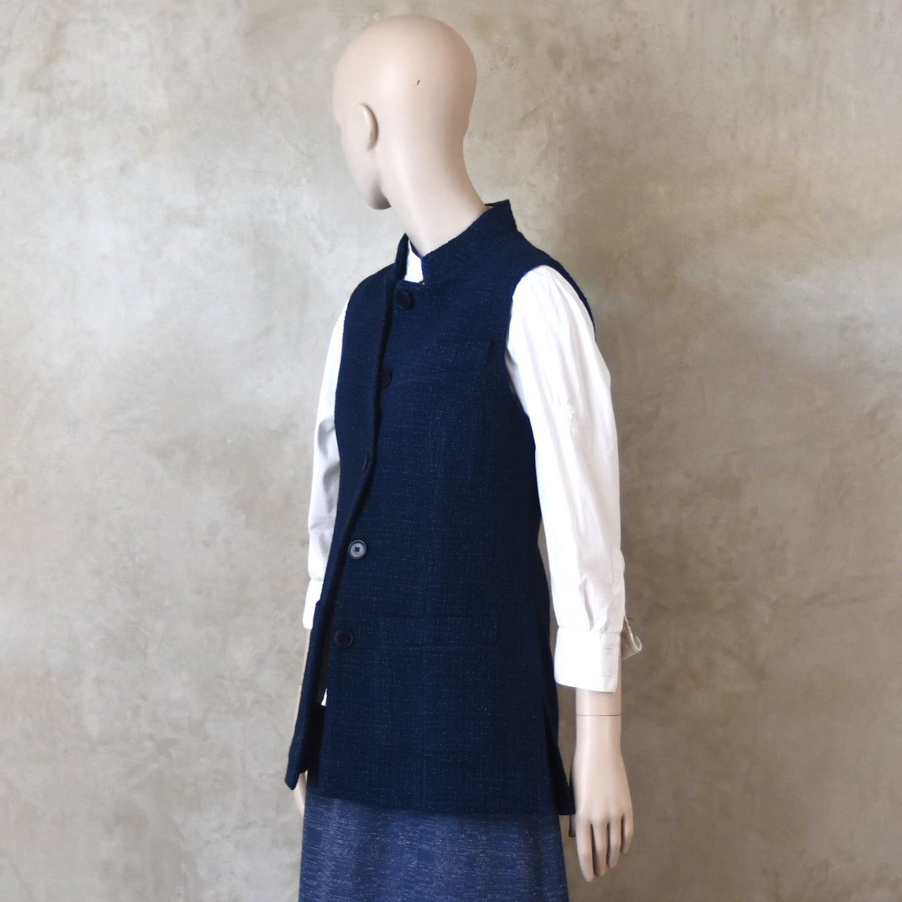 Half Buttoned side front shot of Longer Length Ladies Waistcoat in Linton Tweeds Boucle. A pure cotton weave,  this is superbly trans-seasonal option. Handmade in London. 