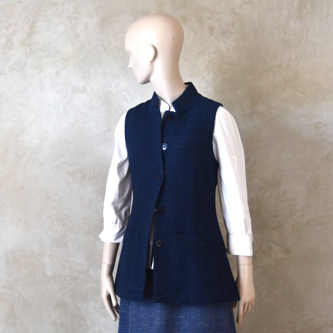 Side Front half buttoned shot of Longer Length Ladies Waistcoat in Linton Tweeds Boucle. A pure cotton weave,  this is superbly trans-seasonal option. Handmade in London. 