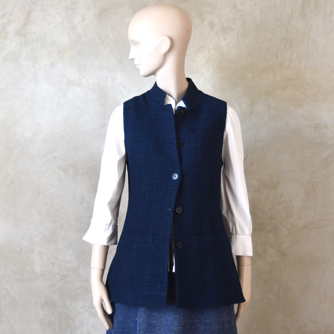 Front half buttoned shot of Longer Length Ladies Waistcoat in Linton Tweeds Boucle. A pure cotton weave,  this is superbly trans-seasonal option. Handmade in London. 