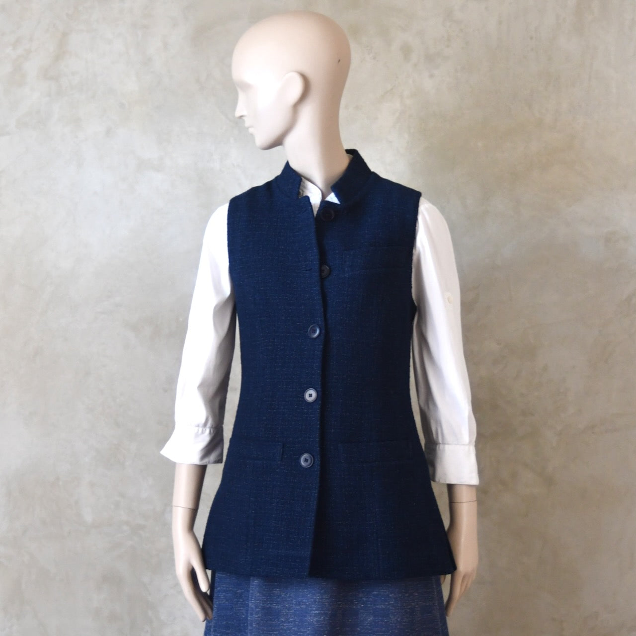 Half Buttoned side front shot of Longer Length Ladies Waistcoat in Linton Tweeds Boucle. A pure cotton weave,  this is superbly trans-seasonal option. Handmade in London. 