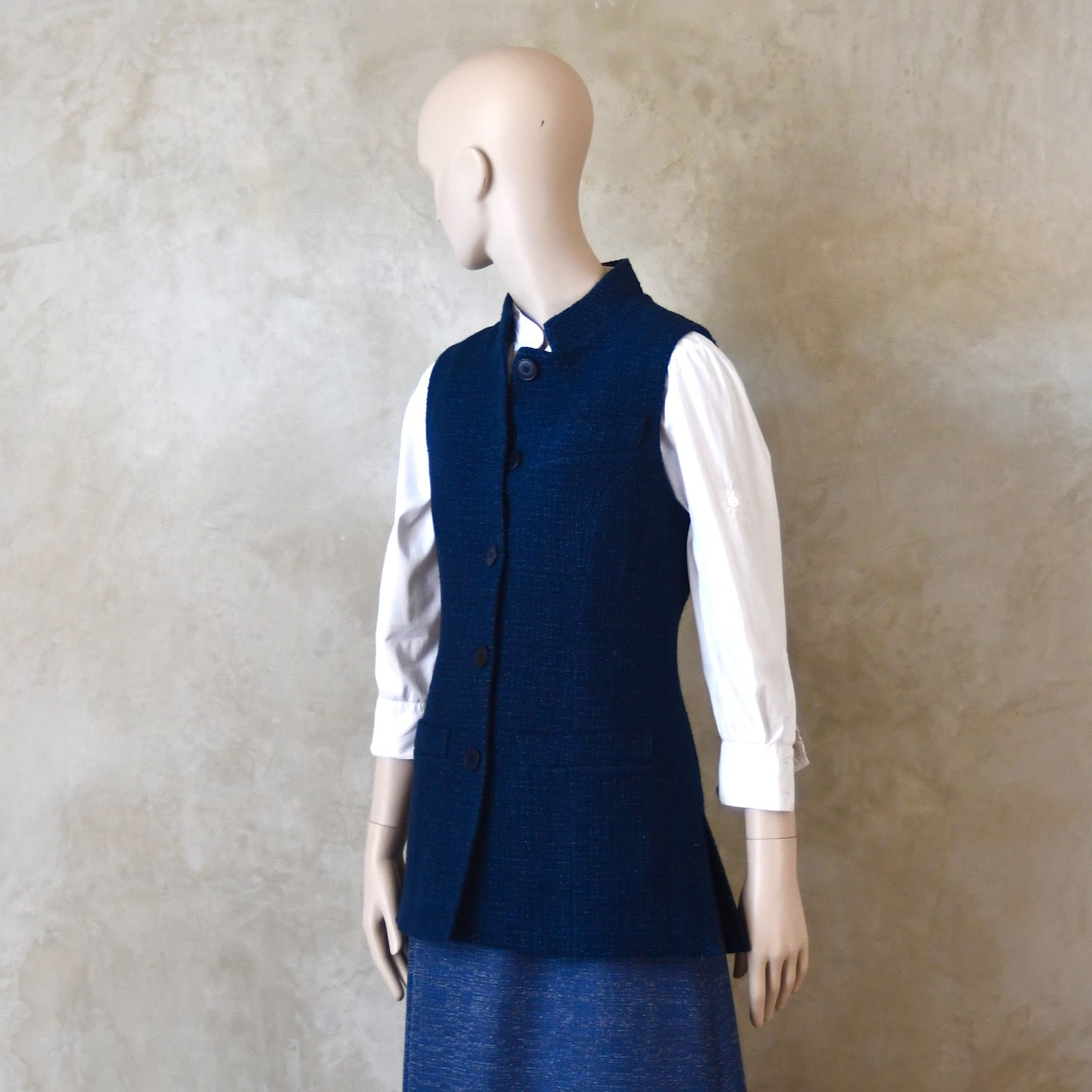 Buttoned side front shot of Longer Length Ladies Waistcoat in Linton Tweeds Boucle. A pure cotton weave,  this is superbly trans-seasonal option. Handmade in London. 