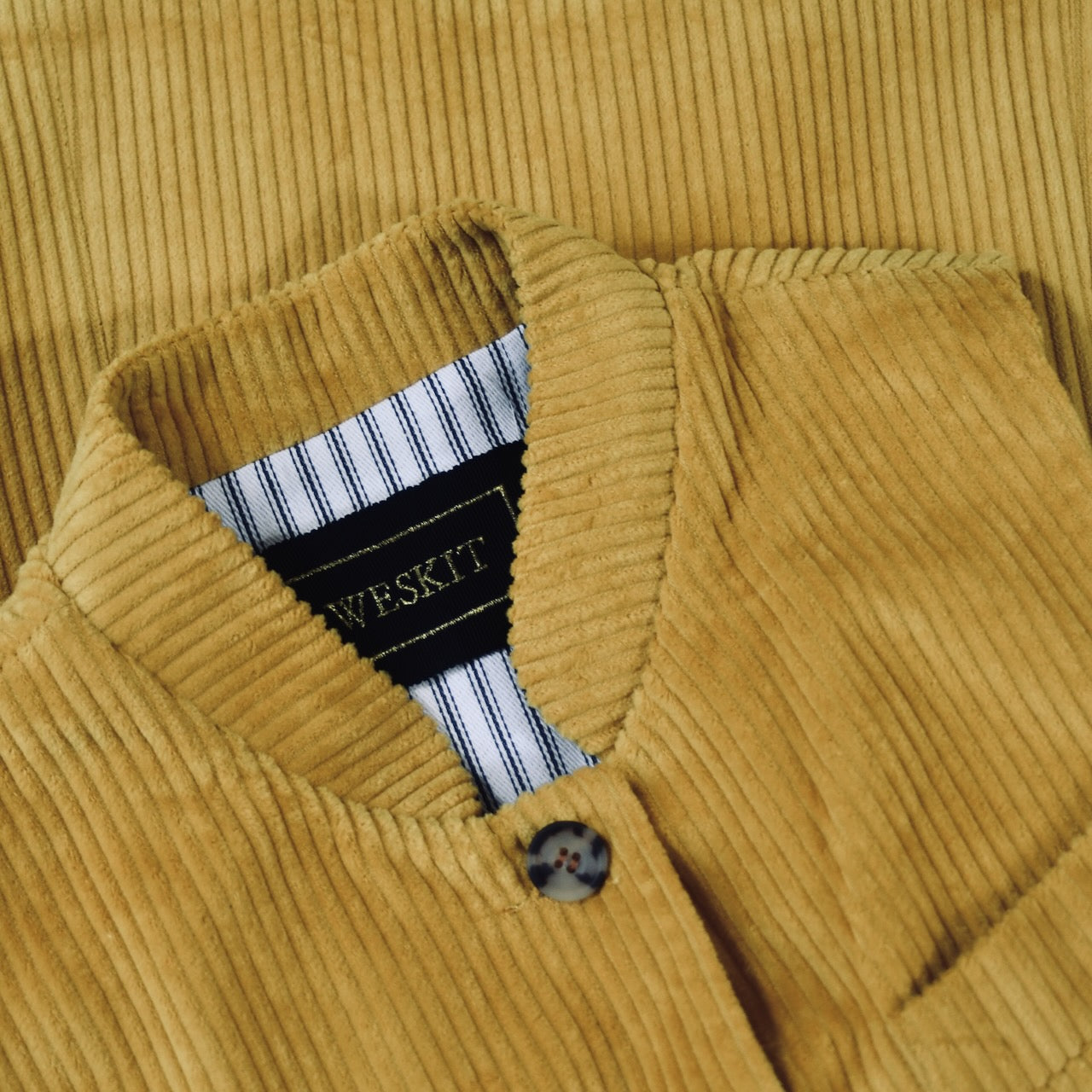 Collar Detail on Ochre-Coloured Ladies Gilet. A pure cotton corduory ladies waistcoat with a longer length and waist shaping. Handmade in London.