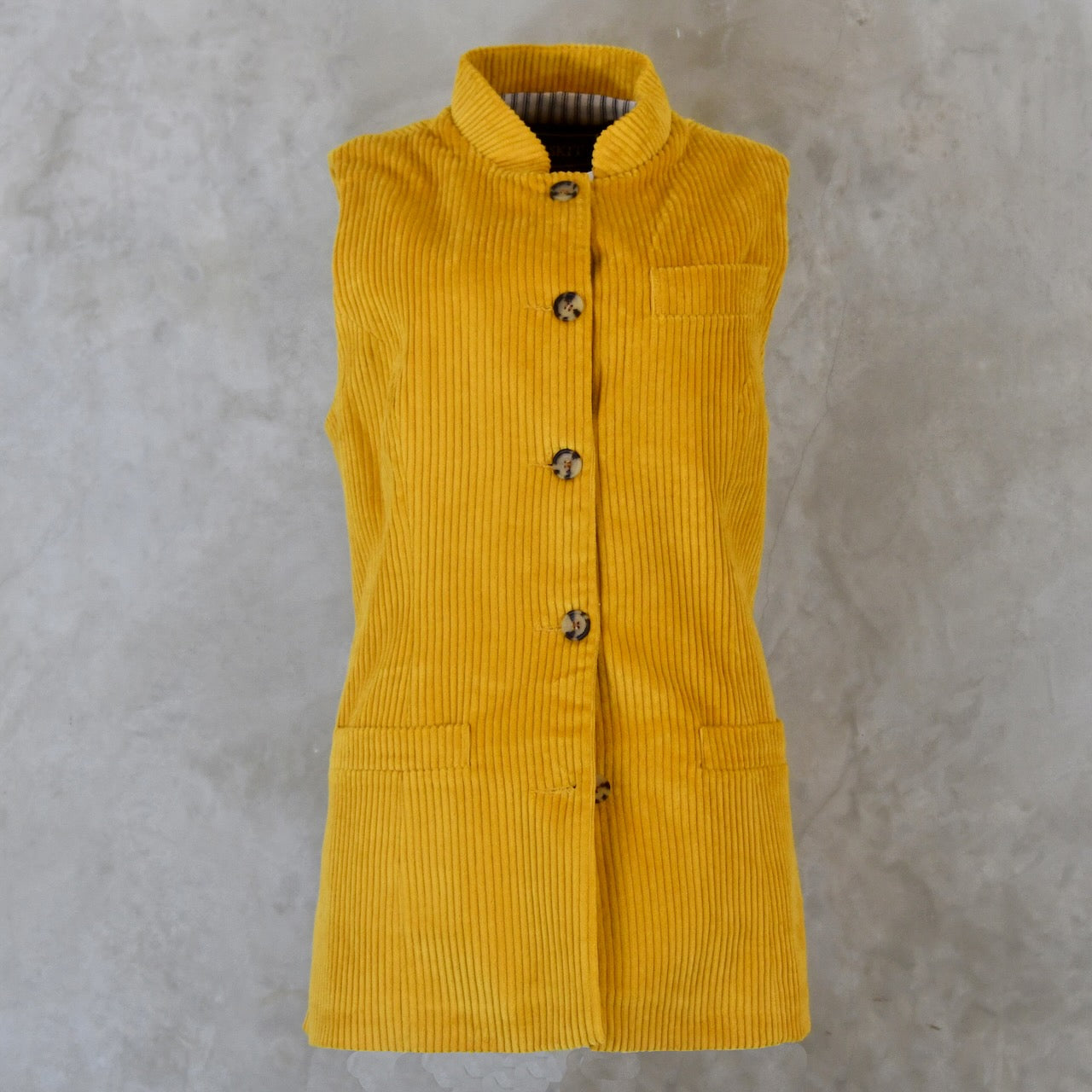 Front View of Ochre-Coloured Ladies Gilet. A pure cotton corduory ladies waistcoat with a longer length and waist shaping. Handmade in London.