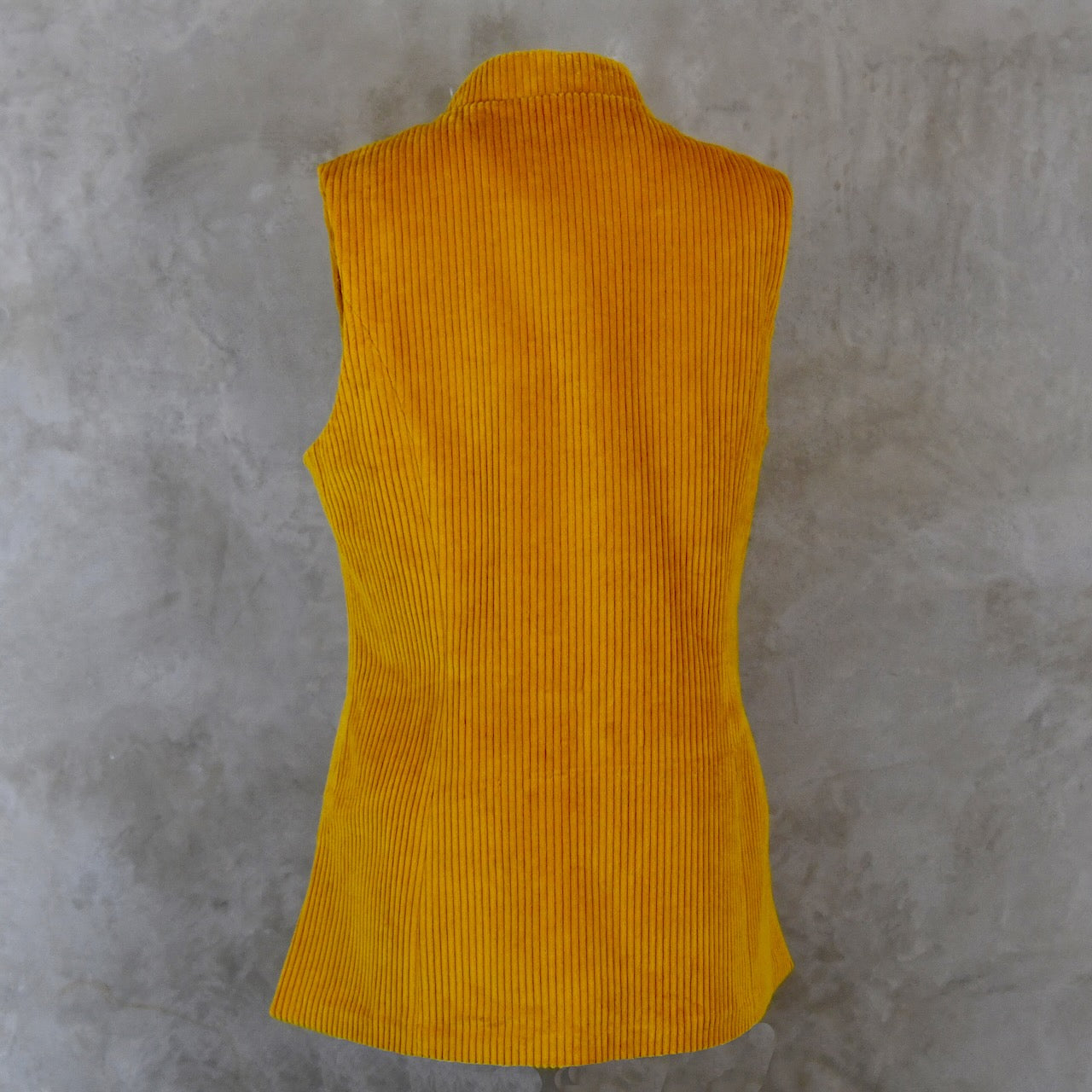 Rear view of Ochre-Coloured Ladies Gilet. A pure cotton corduory ladies waistcoat with a longer length and waist shaping. Handmade in London.