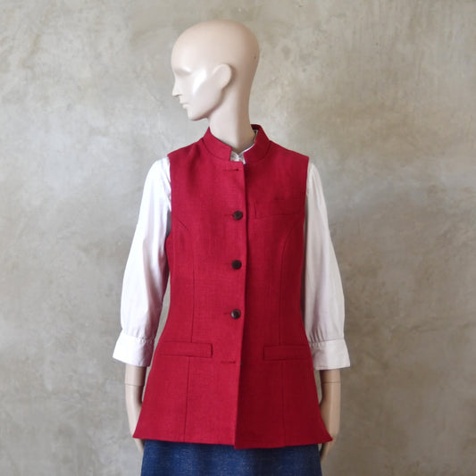 Front Shot of Ladies Shaped Gilet in Red Irish linen. Handmade in London the waistcoat is shown worn over a mustard coloured silk dress by EdNerat.