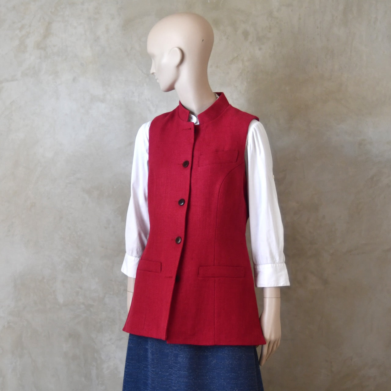 Front buttoned shot of Ladies Shaped Gilet in Red Irish linen. Handmade in London with a Nehru Collar and Cotton Ticking Lining.