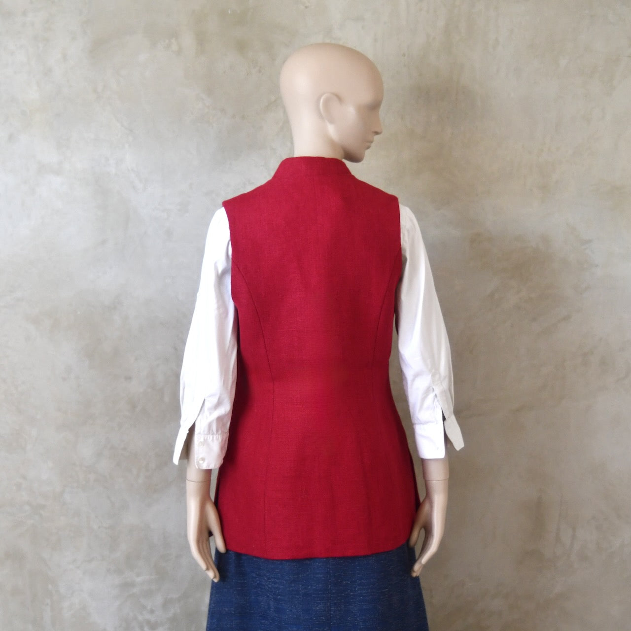 Back shot of Ladies Shaped Gilet in Red Irish linen. Handmade in London with a Nehru Collar and Cotton Ticking Lining.