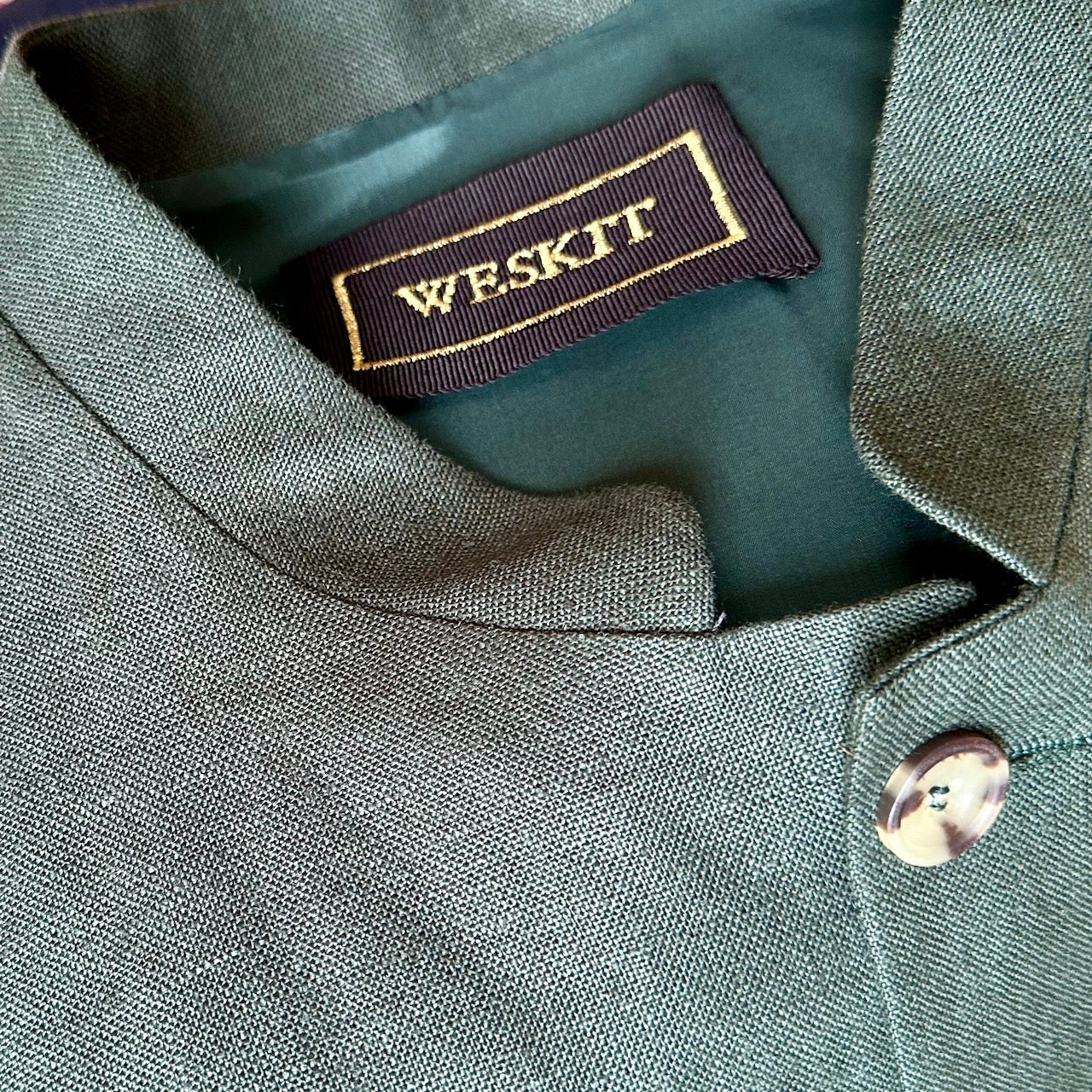Collar Detail on Loose Cut Nehru-Style Gilet in Fine Gree Linen A superb alternative to a jacket with a neat cut and ample pocket space. Smart enough to go out in and relaxed enough for the every-day. 