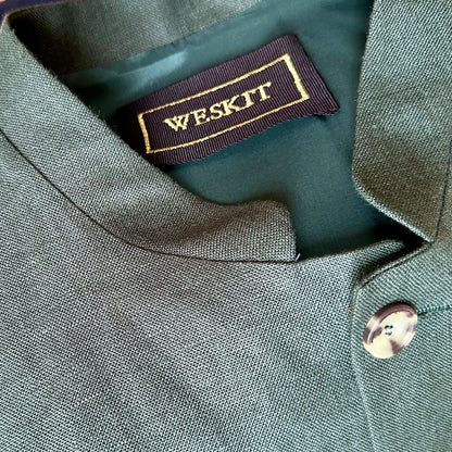Collar Detail on Loose Cut Nehru-Style Gilet in Fine Gree Linen A superb alternative to a jacket with a neat cut and ample pocket space. Smart enough to go out in and relaxed enough for the every-day. 