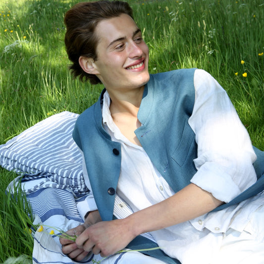 Blue Linen Nehru Style Gilet. Handmade in London this relaxed fit waistcoat has a mandarin collar, three outer and two inner pockets. Made from Irish Linen.