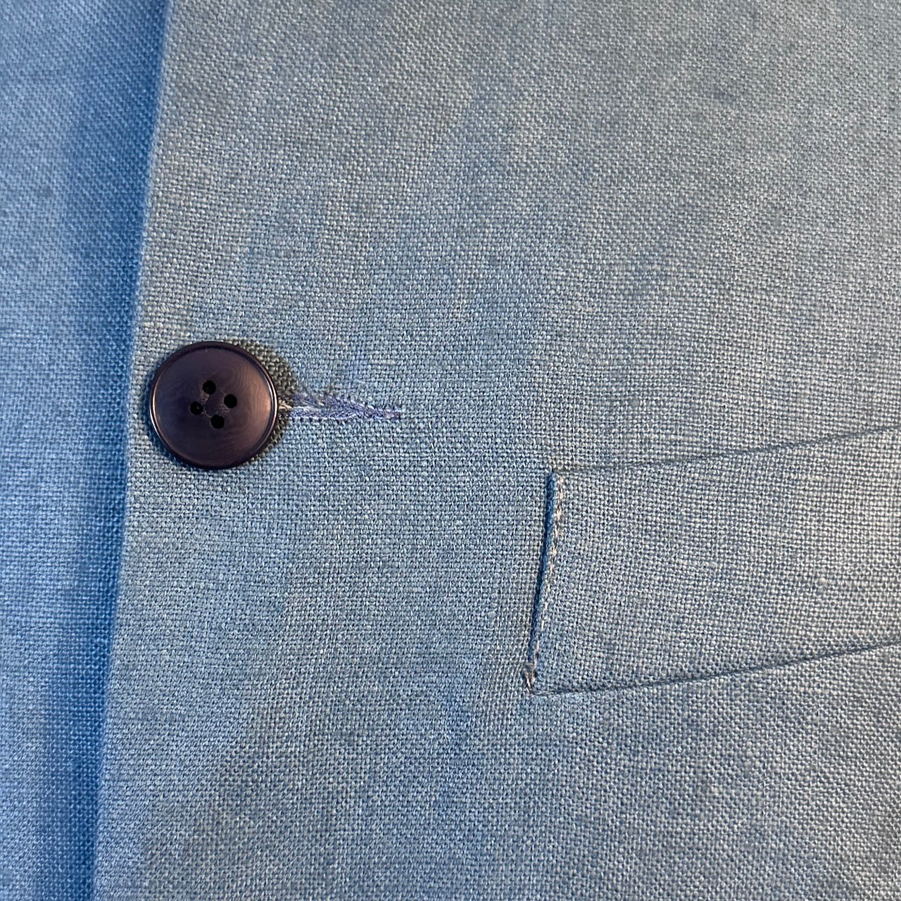 Blue Linen Nehru Style Gilet. Handmade in London this relaxed fit waistcoat has a mandarin collar, three outer and two inner pockets. Made from Irish Linen. Detailed Button View.