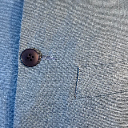 Blue Linen Nehru Style Gilet. Handmade in London this relaxed fit waistcoat has a mandarin collar, three outer and two inner pockets. Made from Irish Linen. Detailed Button View.
