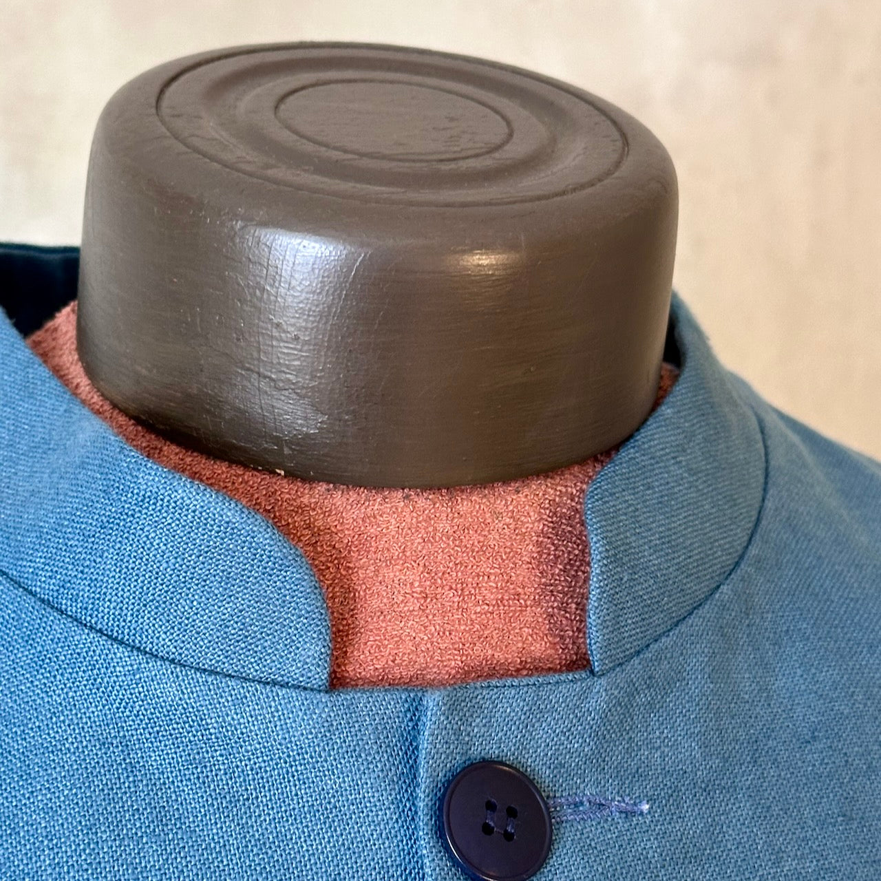 Blue Linen Nehru Style Gilet. Handmade in London this relaxed fit waistcoat has a mandarin collar, three outer and two inner pockets. Made from Irish Linen. Close up of Mandarin Collar.