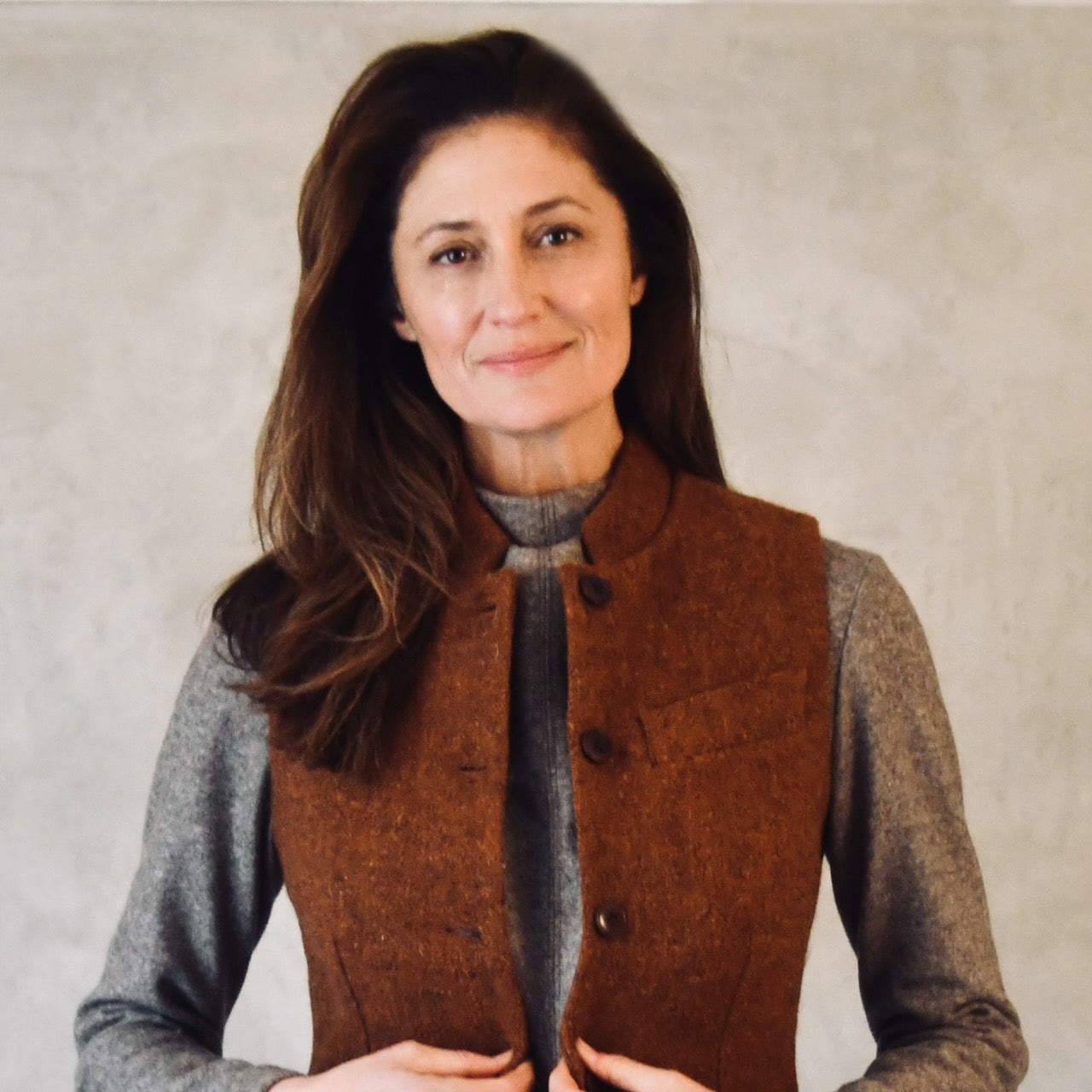 Russet Coloured Lovat Tweed Gilet modelled over brown jumper. Handmade in London. Entirely made in Great Britain.