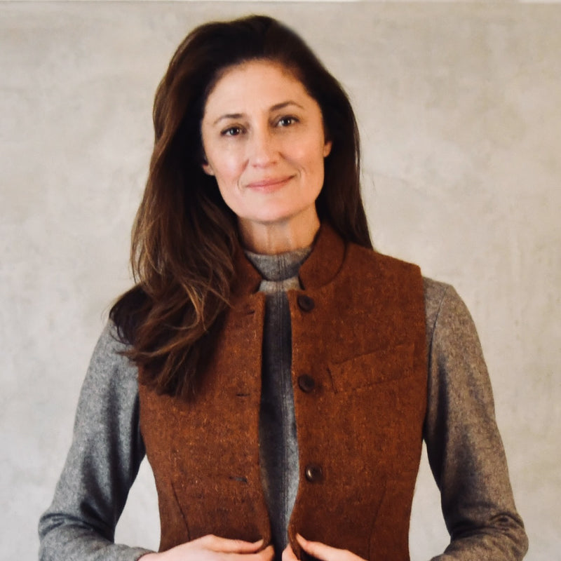Russet Coloured Lovat Tweed Gilet modelled over brown jumper. Handmade in London. Entirely made in Great Britain.