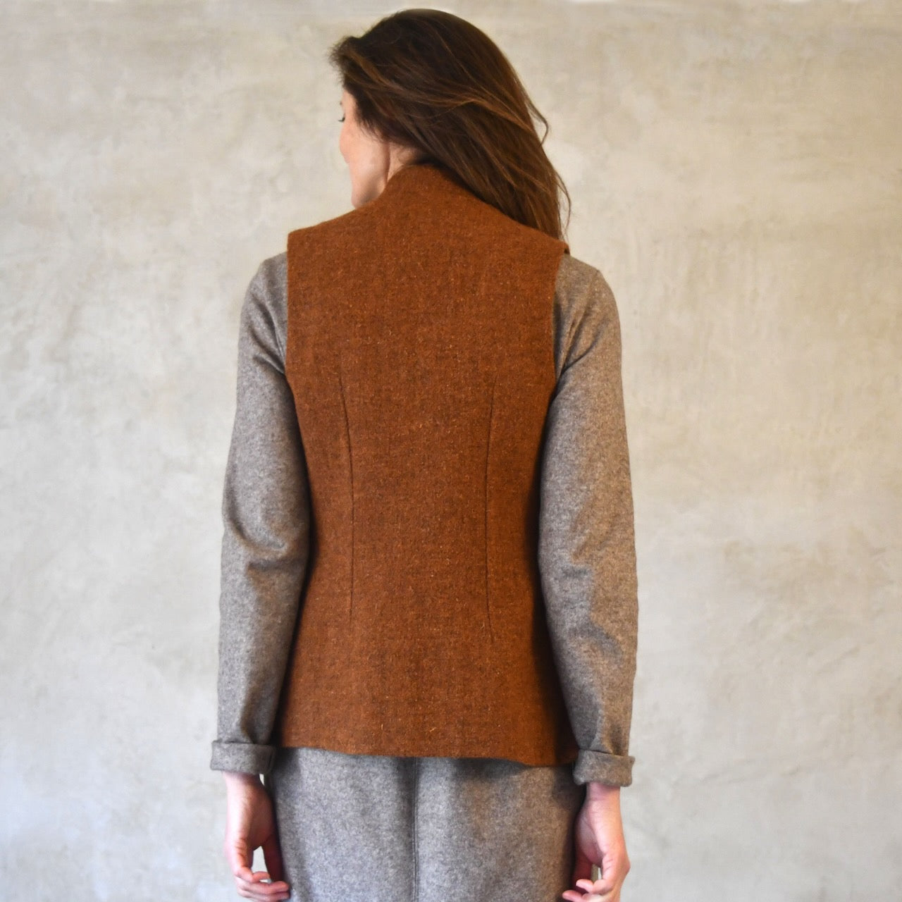 Ladies Classic Cut Tweed Gilet. Bespoke Gilets, handmade in London. Shown in Plain Russet Tweed from Lovat Tweed. Back Shot.