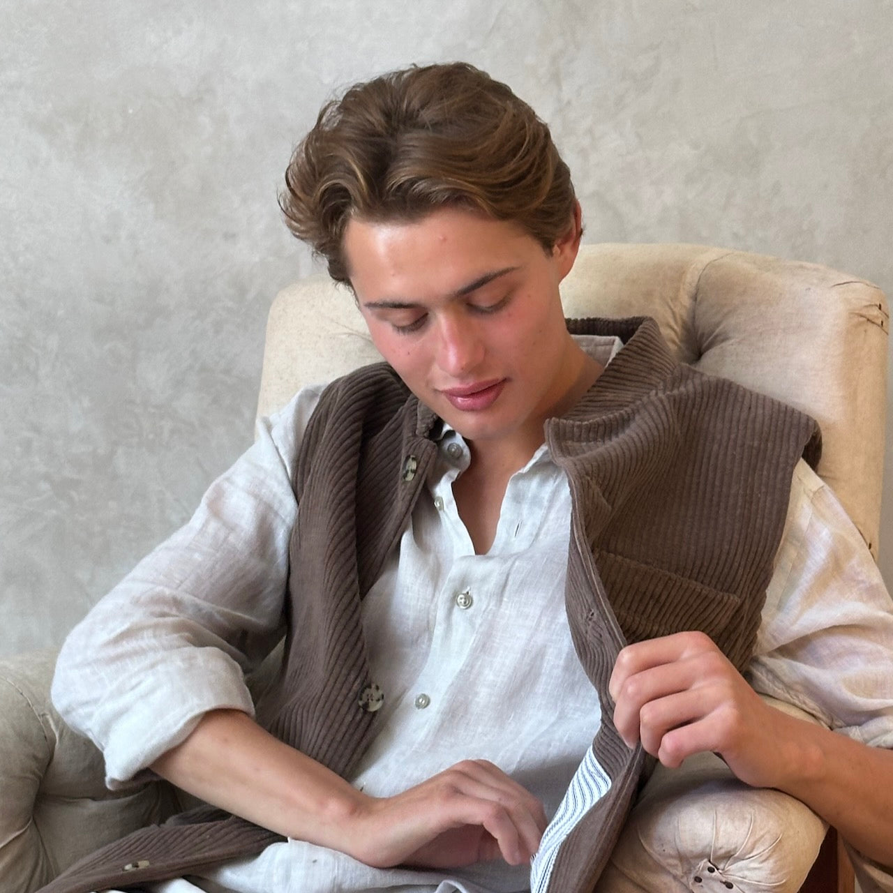 Light Brown Nehru-Style Slim Cut Gilet. This fitted waistcoat has a pure cotton cord outer and pure cotton ticking lining. Handmade in London it is the prefect alternative to a jacket or jumper in the cooler seasons. Seated View.