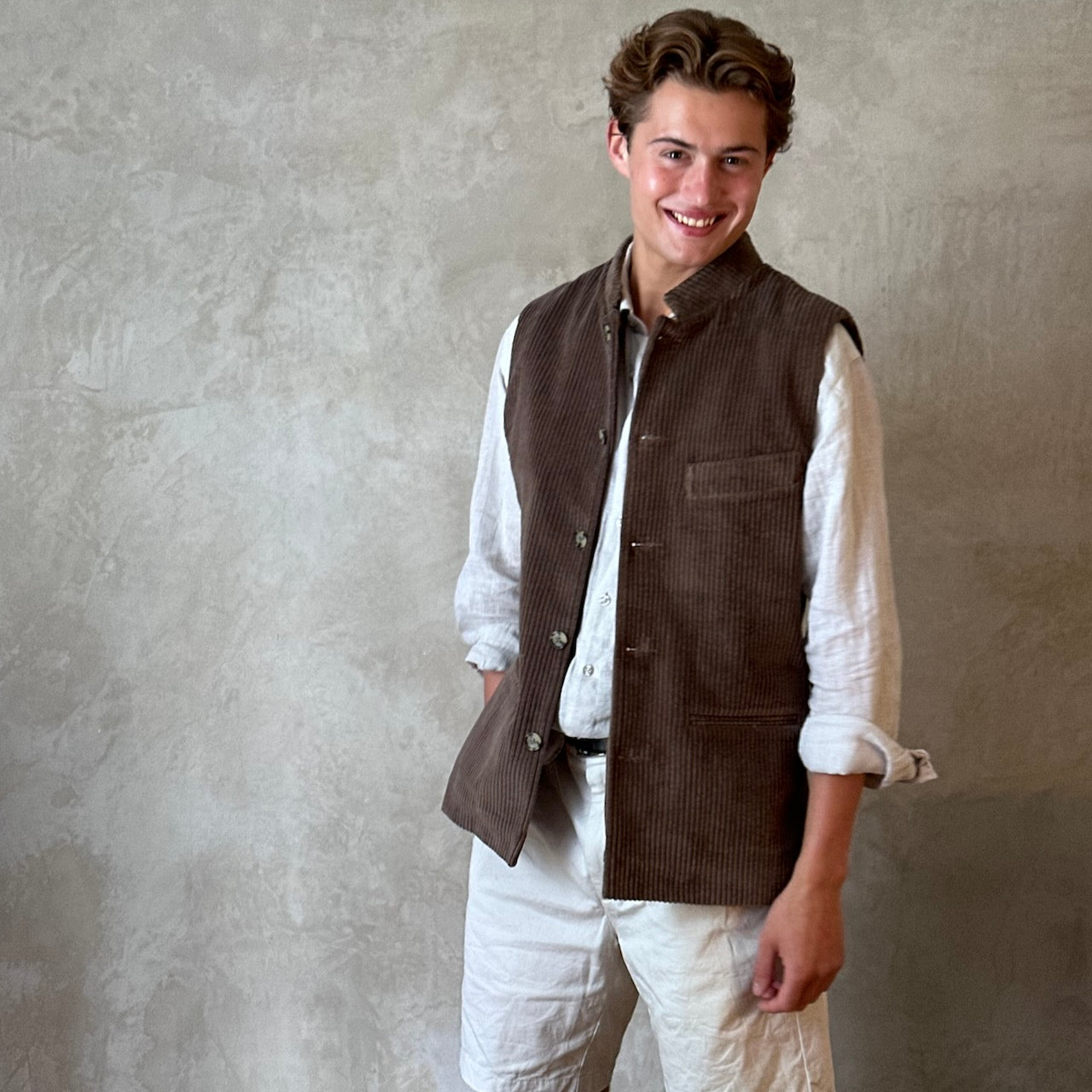 Light Brown Nehru-Style Slim Cut Gilet. This fitted waistcoat has a pure cotton cord outer and pure cotton ticking lining. Handmade in London it is the prefect alternative to a jacket or jumper in the cooler seasons. Standing Shot.