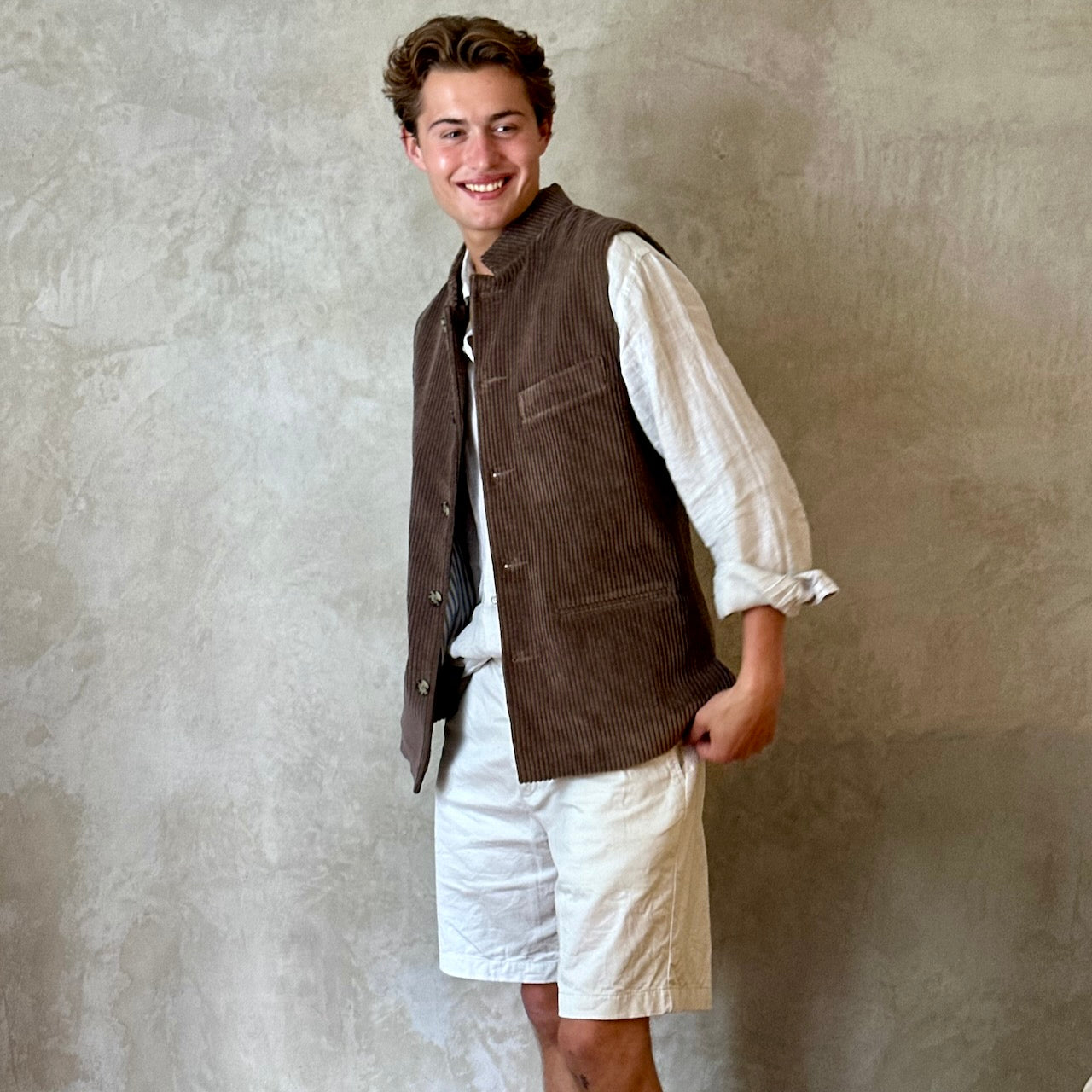 Light Brown Nehru-Style Slim Cut Gilet. This fitted waistcoat has a pure cotton cord outer and pure cotton ticking lining. Handmade in London it is the prefect alternative to a jacket or jumper in the cooler seasons.