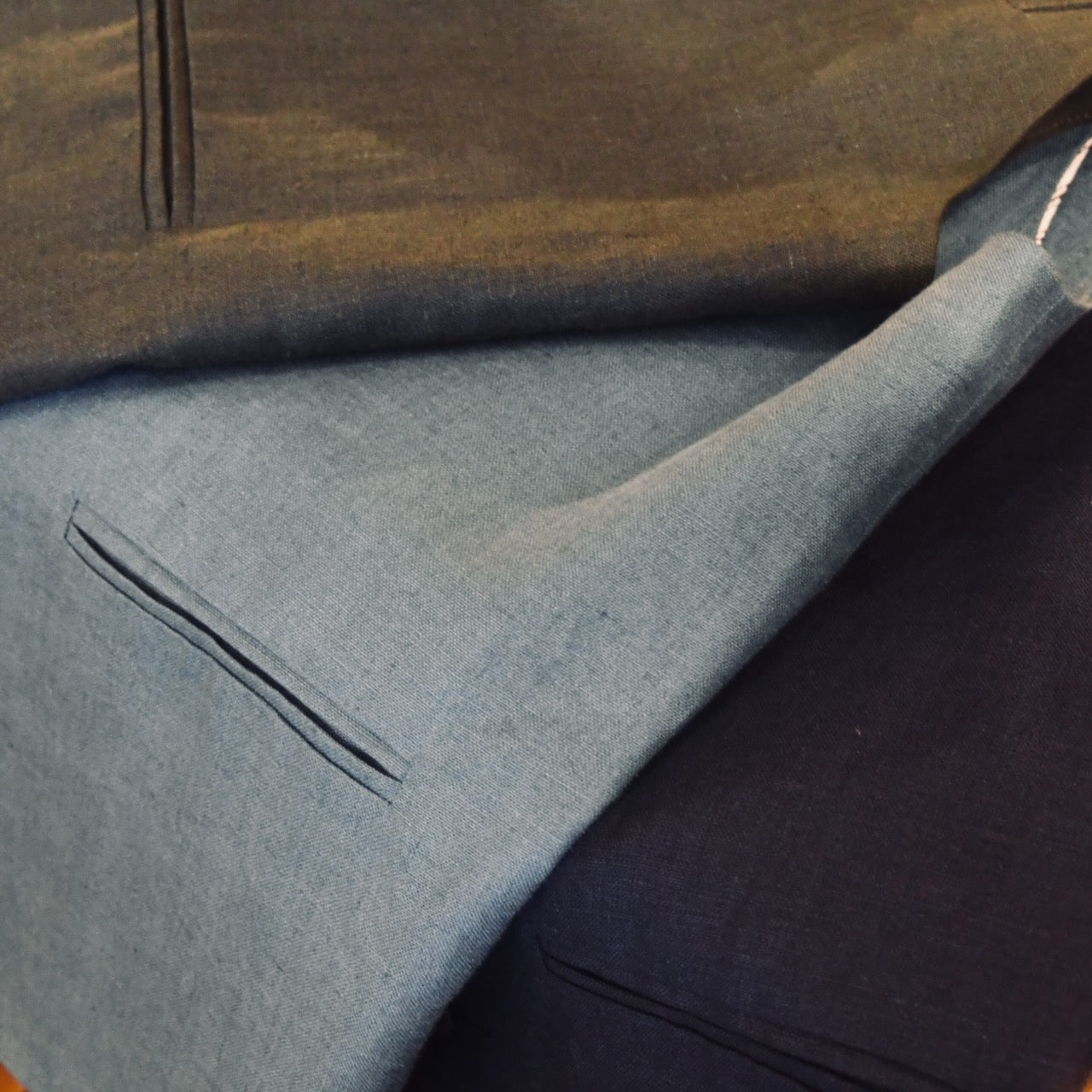 Irish Linens from Baird McNutt for Weskit Gilets and Waistcoats. Handmade in London. Shot showing Bottle Green, Sea Blue and Navy Blue Lightweight Gilets.