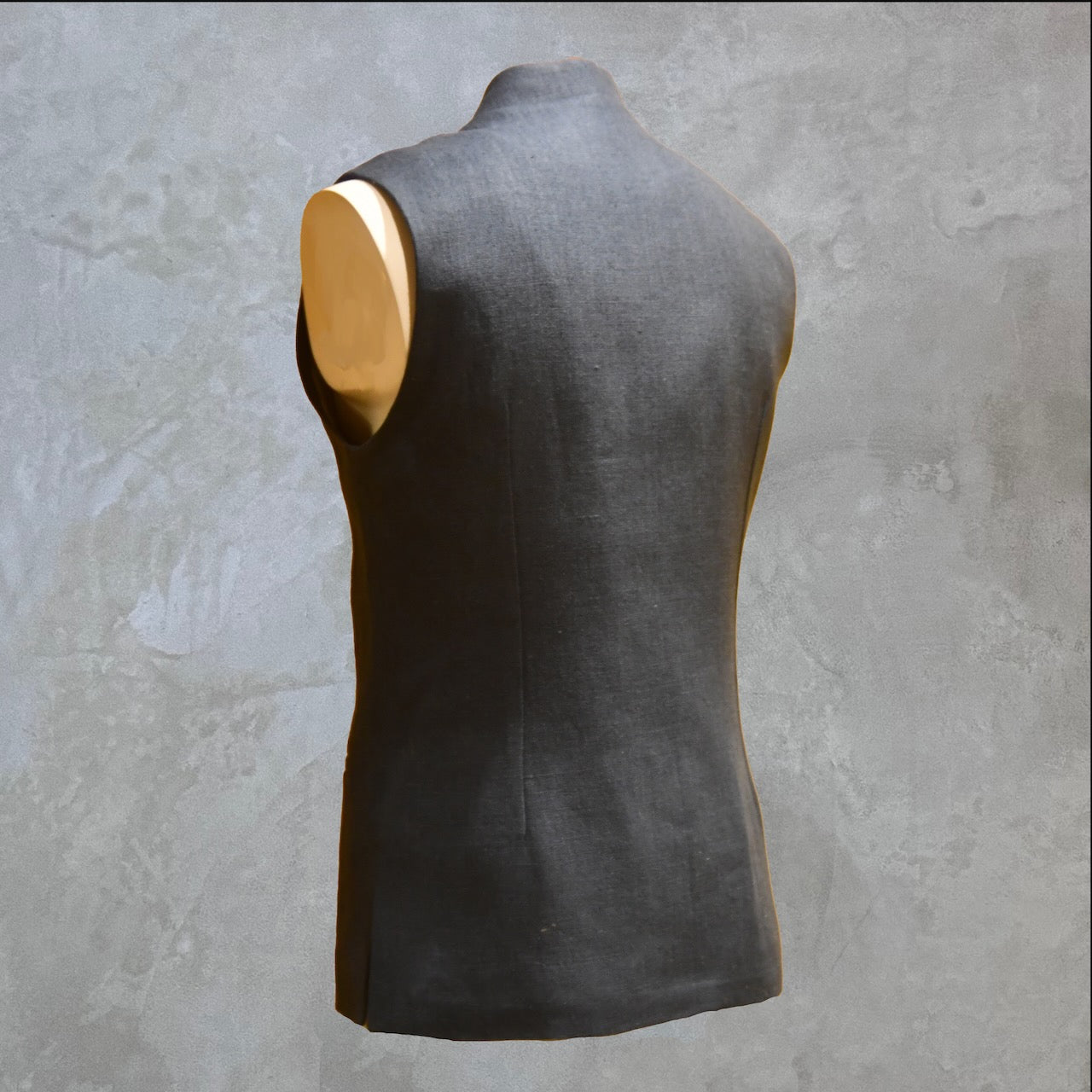 Loose cut Nehru Style Gilet in Deep Navy Linen. This handmade gilet is made from a relaxed mid weight Irish linen. With e Nehru collar detail, three external pockets and a five-buttoned front it is smart enough for work - and yet perfect for the weekend. Side Rear Shot.