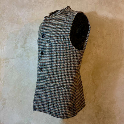 Slim Cut Nehru Style Gilet in Mist Check Lovat Tweed. This waistcoat is made up in a wonderful cross pattern of dark blue-black, brown and teal over a misty grey. Woven by Lovat Mill this is an incredibly warm and well-made tweed. Cut Made and Finished by Hand in London. Entirely made in Great Britain. Mannequin Shot.