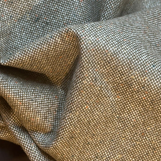 Fabric Detail on Nehru Style Gilet in a Hopsack patterning that gives the overall effect of a misty green. With a weight that will take you from early autumn through until late Spring, this smart tweed will quickly pay its way.
Lined in Cotton Ticking this waistcoat has Flat Horn buttons and a Mandarin collar.
A superb alternative to a jacket or jumper for the cooler days and nights with a slim, tailored cut and ample pocket space. Warm and easy to wear, it will work as well inside 
