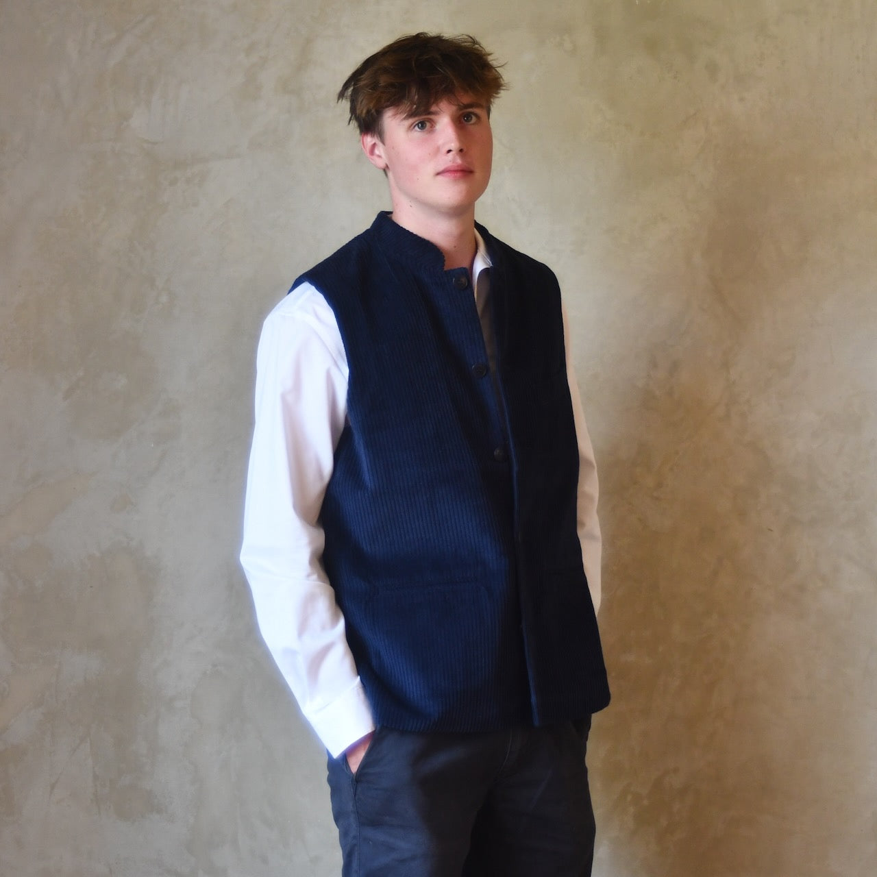 Side on Buttoned View of Navy Cotton Corduroy Loose Cut Gilet. Handmade in London.