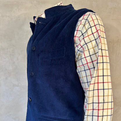 Relaxed fit dark navy cotton corduroy gilet . Made by hand in London this pure cotton waistcoat will wear well for years and keep you warm on cooler days, making a fantastic alternative to a blazer, jacket or jumper.